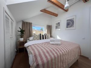 a bedroom with a large bed with a striped blanket at Kapitan S in Gdańsk