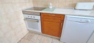 a small kitchen with a sink and a dishwasher at Apartamento Neptuno in Benagil