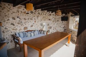 a dining room with a table and a couch at Domus Polymnia, hospitality at its best! in Spílion