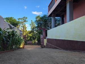 a side view of a building with a balcony at Hotel Tacos plus in Ambatondrazaka