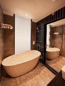 a large bathroom with a large tub and a sink at Ngoc Anh Homestay's in Ha Long +14 photos