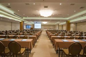a large room with tables and chairs and a screen at Aegean Pearl in Rethymno +29 photos