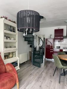 a living room with a spiral staircase and a table at Holiday in Spakenburg Ootje in Spakenburg