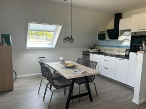 a kitchen with a table and chairs in a room at Friesenhof Meyer in Rastede