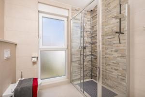 a glass shower in a bathroom with a window at Adults only Guesthouse Villa Samantha by Irundo in Rovinj +65 photos