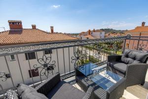 a balcony with a couch and a table on a building at Adults only Guesthouse Villa Samantha by Irundo in Rovinj