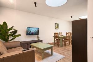 a living room with a couch and a table at The Suite - Eindhoven - By T&S in Eindhoven