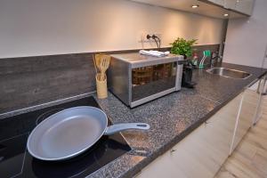 a kitchen with a frying pan on a counter at The Suite - Eindhoven - By T&S in Eindhoven