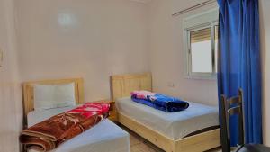 Ένα ή περισσότερα κρεβάτια σε δωμάτιο στο HOTEL 7DAYS DAkHLA