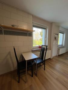 a dining room with a table and chairs and a window at Cozy 1-room apartment in Hannover