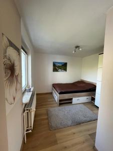 a small bedroom with a bed and a window at Cozy 1-room apartment in Hannover