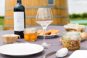a table with a bottle of wine and a wine glass at Coup 2 Foudres in Saint-Jean-de-Blaignac