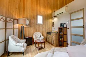 a bedroom with a bed and two chairs and a table at Coup 2 Foudres in Saint-Jean-de-Blaignac