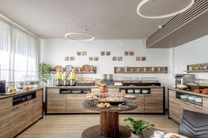 a large kitchen with a table with food on it at Best Western Hotel Residence Italia in Quartu SantʼElena