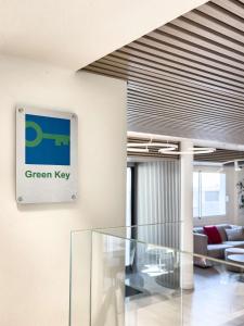 an office lobby with a green key sign on the wall at Best Western Hotel Residence Italia in Quartu SantʼElena +93 photos