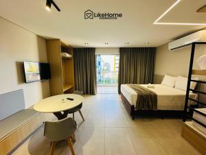 a hotel room with a bed and a table at Edifício Box 150 - LikeHome Hospedagens in João Pessoa