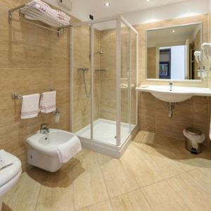 a bathroom with a shower and a sink and a toilet at Confidence Hotel Viadana in Viadana +44 photos
