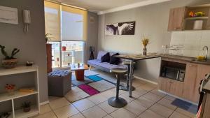 a kitchen and living room with a couch and a table at Departamento Quilpué full equipado in Quilpué