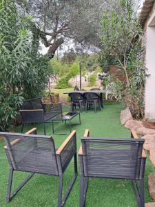 a group of chairs and tables on the grass at Mini Villa Giuseppina in Bonifacio