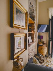 a living room with two framed pictures on the wall at Lyssa Holiday Apartments in Taormina
