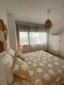 a bedroom with a large bed and a large window at Casa Mateo in Jedula
