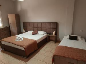 a hotel room with two beds in a room at Villa Pavlina in Olympiada