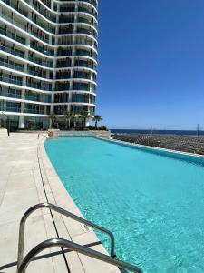 a large swimming pool next to a large building at Ayia Napa Marina Exclusive Apartment in Ayia Napa