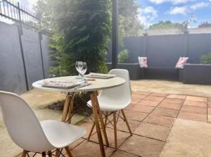 a white table and chairs on a patio at The Midlands Protea in Howick