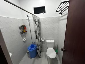 a small bathroom with a toilet and a tv at Langlang house in Dutunan