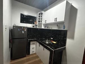 a kitchen with a sink and a black counter top at Langlang house in Dutunan