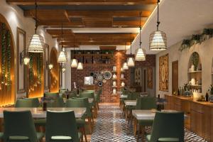 a dining room with tables and green chairs at Hotel Global Retreat in Digha
