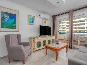 a living room with a tv and a couch and a table at Apartment Las Terrazas by Interhome in Marbella