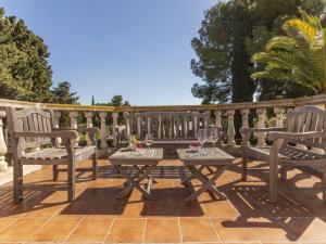 a wooden deck with two benches and a table at Holiday Home Serge by Interhome in Cambrils