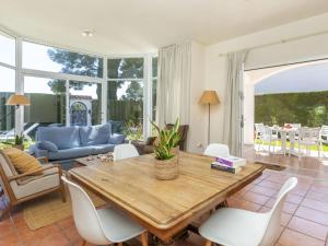 a living room with a wooden table and chairs at Holiday Home Serge by Interhome in Cambrils +21 photos