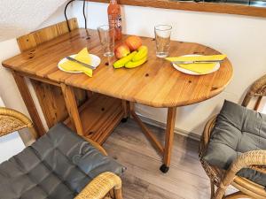 a wooden table with bananas and fruit on it at Apartment Gollwitzer Park - Insel Poel-8 by Interhome in Gollwitz