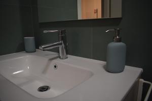 a white bathroom sink with a soap dispenser on it at RelaxArte Cisanello Pisa in Pisa
