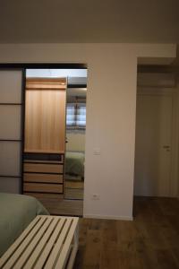 a bedroom with a bed and a closet and a mirror at RelaxArte Cisanello Pisa in Pisa