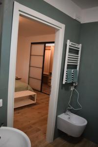 a bathroom with a white sink and a mirror at RelaxArte Cisanello Pisa in Pisa