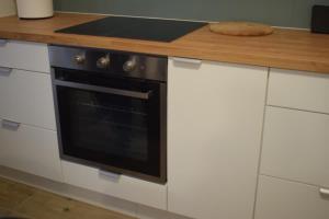 a kitchen with a stove and a wooden counter top at RelaxArte Cisanello Pisa in Pisa