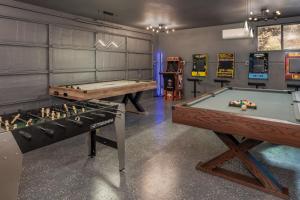 a billiard room with two ping pong tables at Yosemite Sunrise House with hot tub/views/game room! in Yosemite Forks