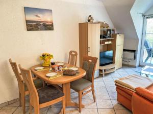 a dining room with a table and chairs in a room at Apartment Gollwitzer Park - Insel Poel-10 by Interhome in Gollwitz