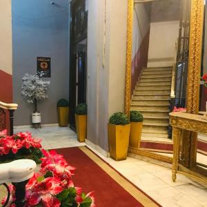 a hallway with a mirror and stairs in a building at Hotel velvet One in Cairo