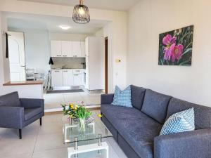 a living room with a couch and a table at Apartment Casa Stella App- 4 by Interhome in Brissago +10 photos