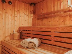a sauna with two towels sitting on a bench at Chalet Le Cyclamen by Interhome in Champoussin