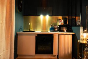 a kitchen with a sink and a stove at Rêve d'or 2 in Déville-lès-Rouen