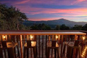 a balcony with chairs and a view of a mountain at Yosemite Lookout Lodge w/ hot tub, firepits, game room, and more in Oakhurst