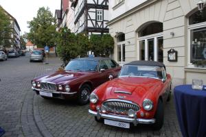 two old cars parked next to each other on a street at Hotel Werratal in Bad Sooden-Allendorf