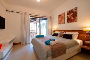 a bedroom with a bed with a stuffed animal on it at Beachfront chic retreat in Post of Flacq +41 photos