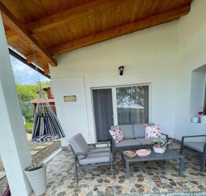 a patio with a couch and chairs and a table at Casa Mimi in Oradea