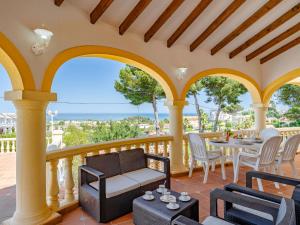 a patio with a table and chairs on a balcony at Villa Villa Rosa by Interhome in Denia